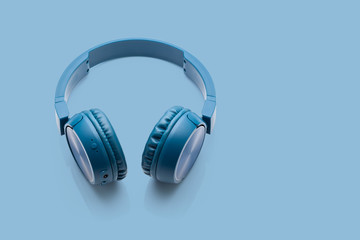 bluetooth blue headphone on blue background