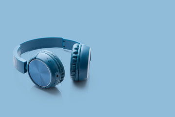 bluetooth blue headphone on blue background