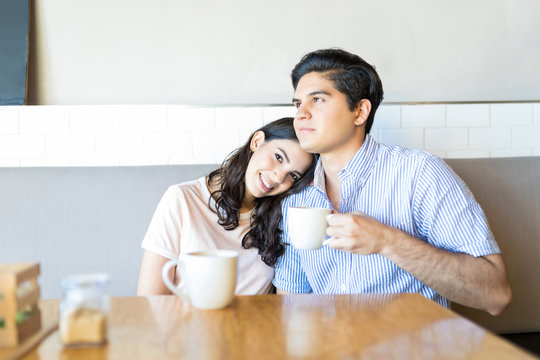 Couple Having Relaxing Time In Cafe