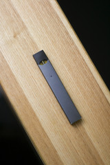 E-Cigerette on Wood background