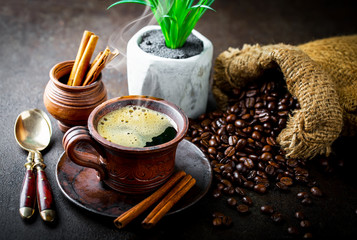 Black coffee in a cup on old background