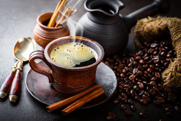 Black coffee in a cup on old background