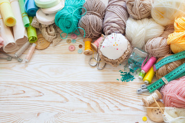 Many different rainbow materials for needlework and sewing. A girl / woman is drinking tea.