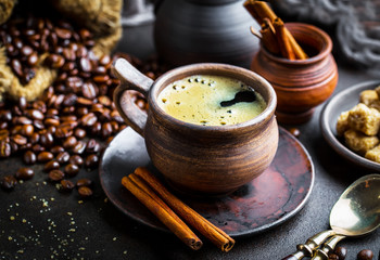 Black coffee in a cup on old background