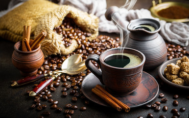 Black coffee in a cup on old background