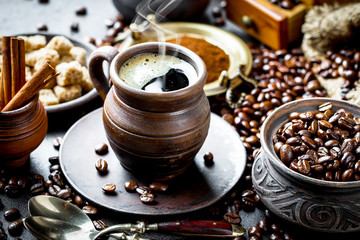 Black coffee in a cup on old background