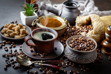 Black coffee in a cup on old background