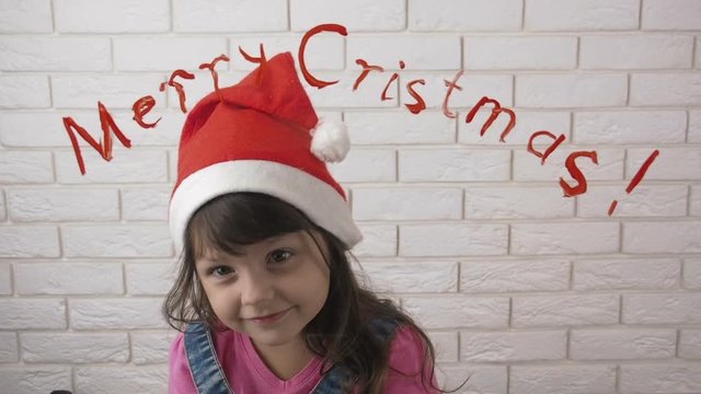 Merry Christmas. Cheerful child in a Santa Claus hat.