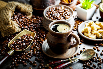 Black coffee in a cup on old background