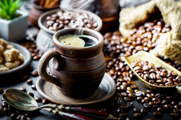 Black coffee in a cup on old background