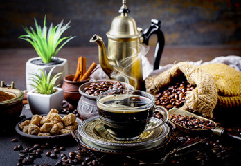 Black coffee in a cup on old background