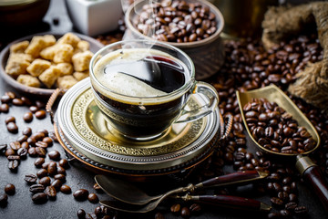 Black coffee in a cup on old background