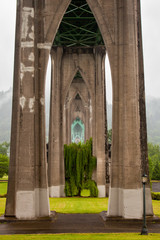 View southwest underneath the St. Johns Bridge and across Cathedral Park in Portland, Oregon, USA