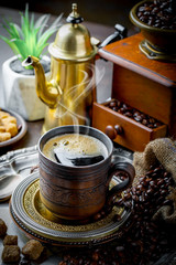 Black coffee in a cup on old background