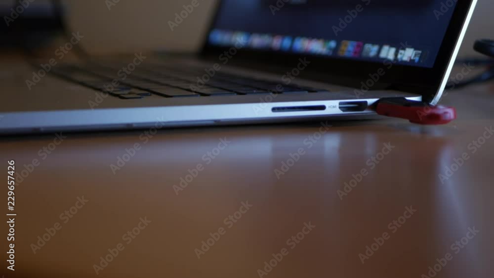 Poster universal serial bus being inserted into a laptop.