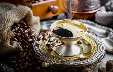 Black coffee in a cup on old background