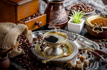 Black coffee in a cup on old background
