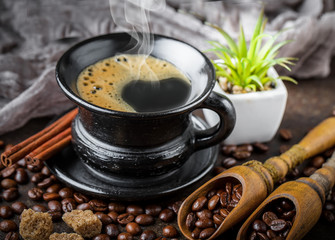 Black coffee in a composition with kitchen accessories