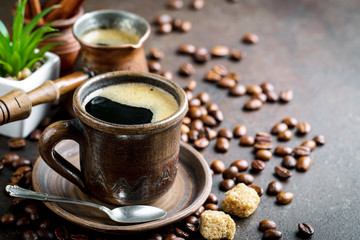 Black coffee in a cup on old background