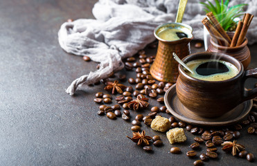 Black coffee in a cup on old background