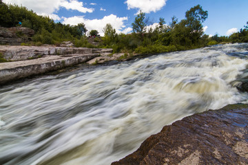 A small rapid at the  middle of Hirsky Tikych river with swallow water in Buky, Cherkasy region, Ukraine