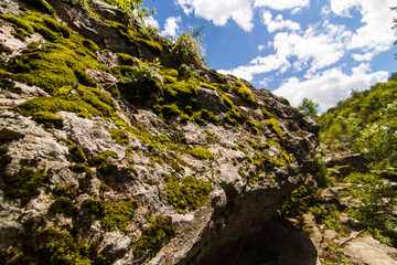 Beautiful view of the mossed rocks and stones in Buky, Ukraine with blue sky on background