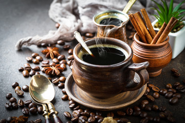 Black coffee in a cup on old background