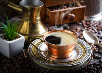 Black coffee in a cup on old background