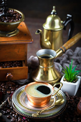 Black coffee in a cup on old background