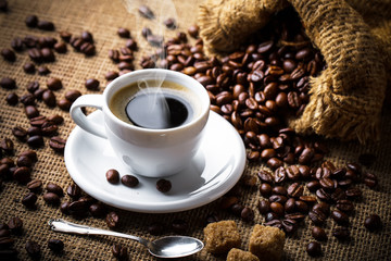 Black coffee in a cup on old background