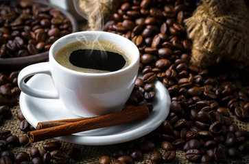 Black coffee in a cup on old background