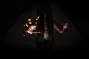 ghost women hand in haunted hotel with dark filter, halloween concept