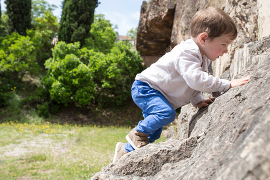 3 years old child boy climbing rock