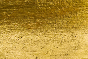 concrete gold background. abstract golden texture layout design. gold color painted on cement wall...