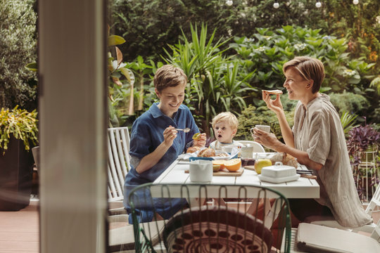 Smiling mothers with child at breakfast table