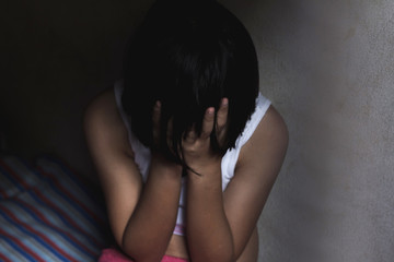 Obraz premium traumatized young girl in bed room, concept photo of sexual and trafficking assault,traumatized young girl