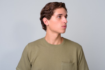 Young handsome man with wavy hair against white background