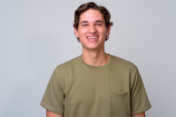 Young handsome man with wavy hair against white background