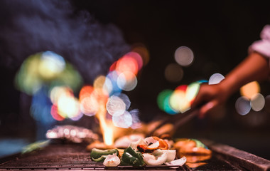 chef cook the bbq seafood in near beach for dinner party