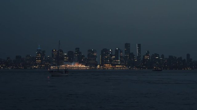 Twilight over Vancouver downtown skyline with yacht in foreground
