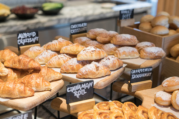 A variety of fresh croissant homemade in luxury hotel breakfast buffet, restaurant interior.