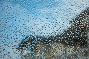 Focused on rain drops on glass car