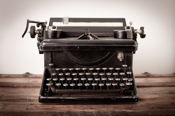 Vintage Metal Typewriter on Old Wooden Trunk