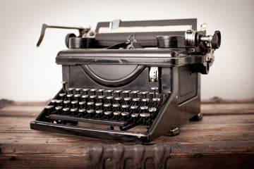 Vintage Metal Typewriter on Old Wooden Trunk