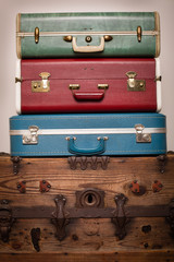Vintage Suitcases Sitting on Old Wooden Trunk