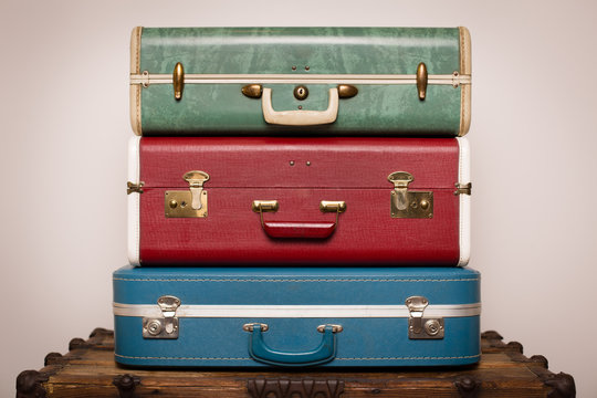 Vintage Suitcases Sitting on Old Wooden Trunk