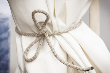 Waterproof white tarpaulin or curtain tied string