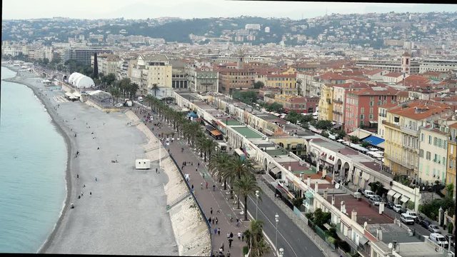 People walking on English promenade of French luxury city of Nice. City view. Concept of travel. Locked down real time establishing shot
