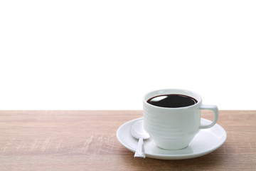 a cup of coffee and spoon on wood desk isolated and white background