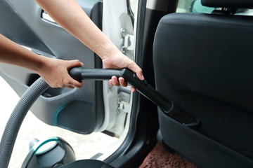 woman hands using vacuum cleaner interior car